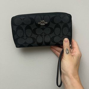 Black Coach wristlet with tags.